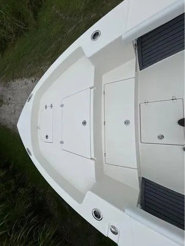 Slide: The Image of 2025 Pathfinder 2700 Open boat with T-top speakers, under clear blue sky. - 24