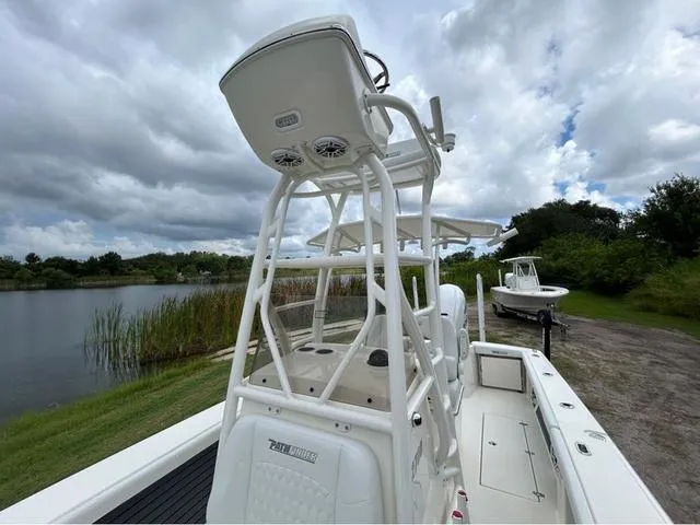 Slide: The Image of 2025 Pathfinder 2700 Open boat interior with outboard motor, parked in a sunny lot. - 27