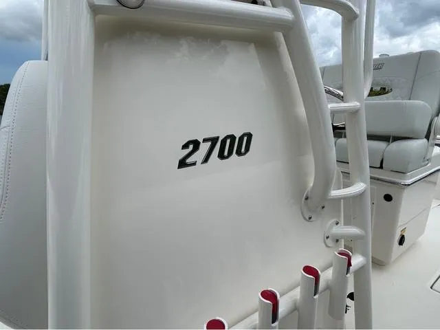 Slide: The Image of 2025 Pathfinder 2700 Open boat interior with seating and motor, parked outdoors. - 28