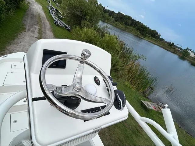 Slide: The Image of 2025 Pathfinder 2700 Open boat interior with open hatch and visible storage compartment. - 30