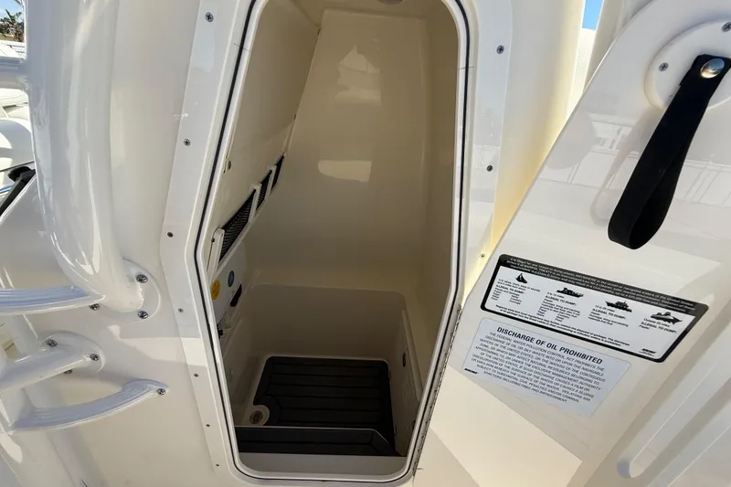 Slide: The Image of 2025 Pathfinder 2700 Open boat interior storage compartment with safety instructions. - 42