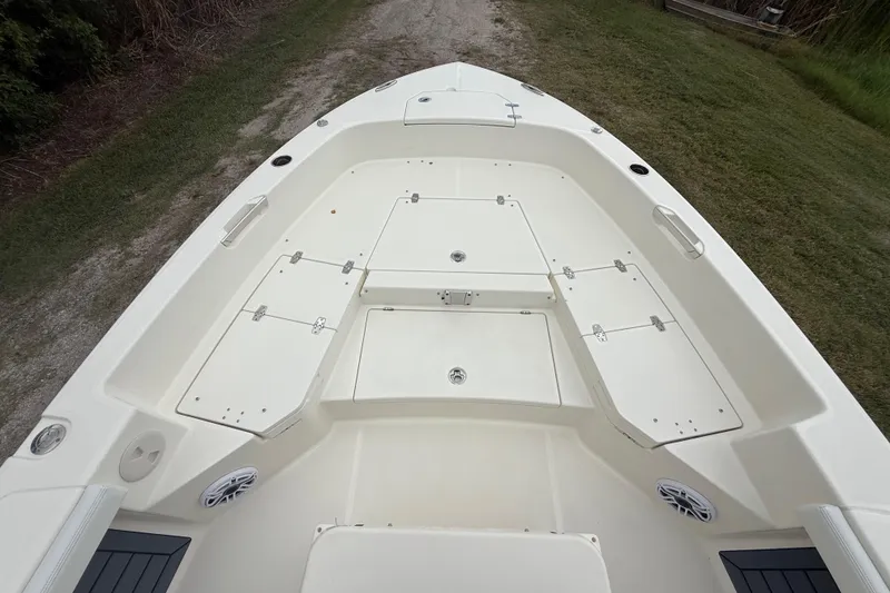 Slide: The Image of 2025 Pathfinder 2400 TRS boat deck with storage compartments and speakers. - 18
