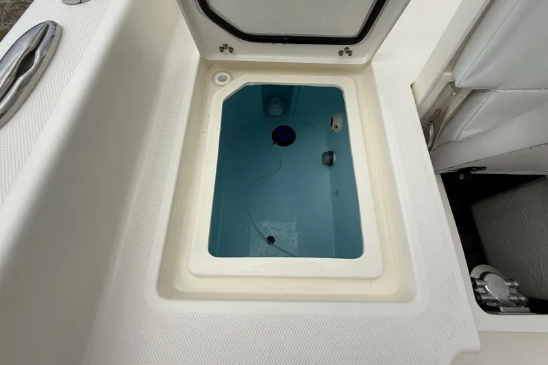 Slide: The Image of Open storage compartment on 2025 Pathfinder 2400 TRS boat, featuring a clean, white interior. - 27