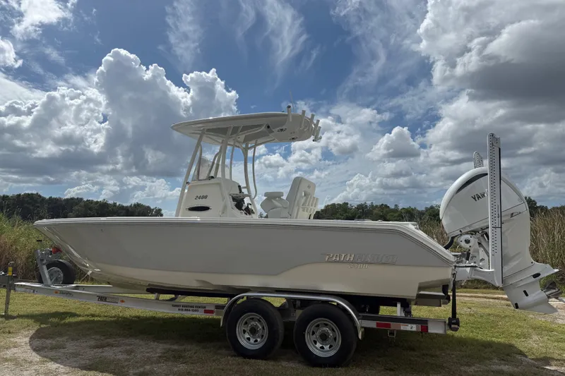Slide: The Image of 2025 Pathfinder 2400 TRS boat on trailer under cloudy sky. - 3