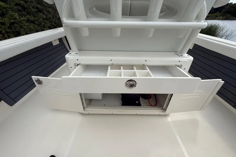 Slide: The Image of 2025 Pathfinder 2400 TRS boat storage compartment with open drawers and organized sections. - 31