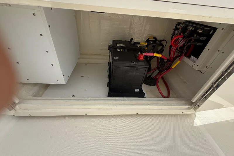 Slide: The Image of Battery compartment of 2025 Pathfinder 2400 TRS boat with wiring and connections. - 32