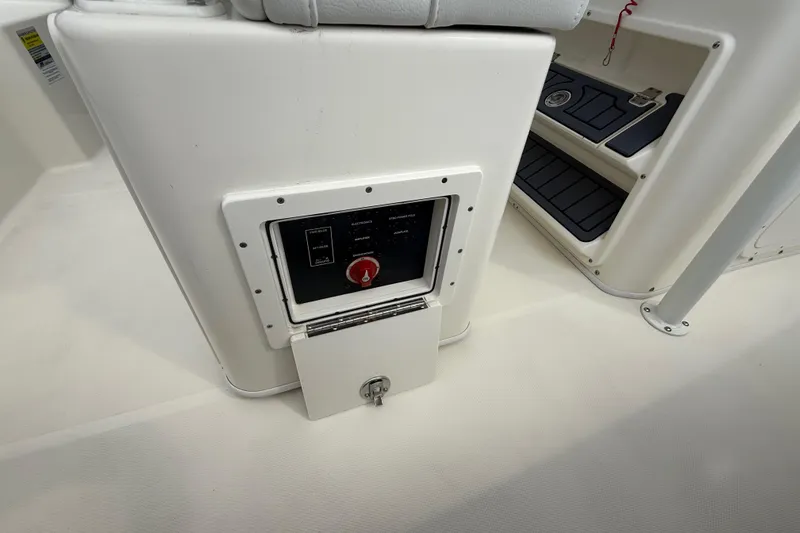 Slide: The Image of Control panel on a 2025 Pathfinder 2400 TRS boat, featuring a red switch. - 34