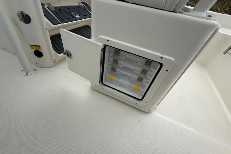 Slide: The Image of Open storage compartment on 2025 Pathfinder 2400 TRS boat, showcasing organized interior. - 36