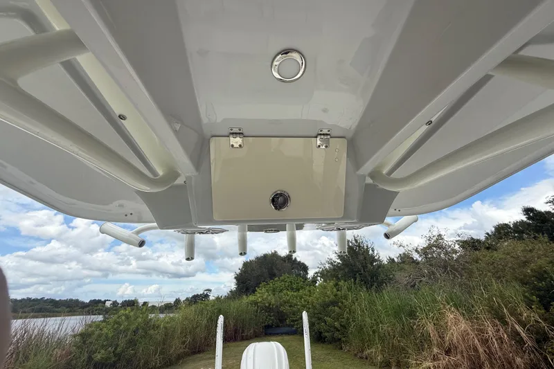 Slide: The Image of 2025 Pathfinder 2400 TRS boat underside view with rod holders and storage compartment. - 41