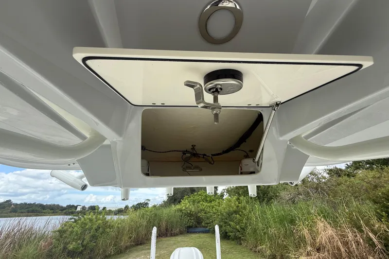 Slide: The Image of 2025 Pathfinder 2400 TRS boat storage compartment, open view, with scenic background. - 42