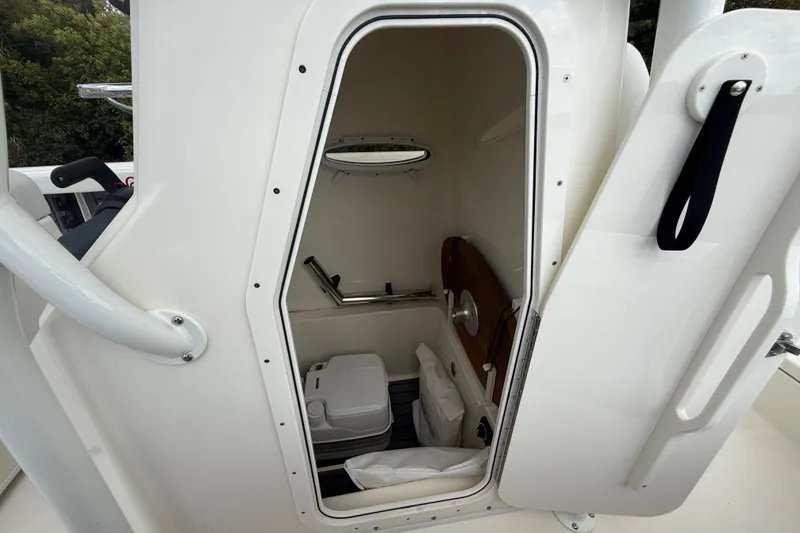 Slide: The Image of 2025 Pathfinder 2400 TRS boat interior with compact cabin and amenities. - 44