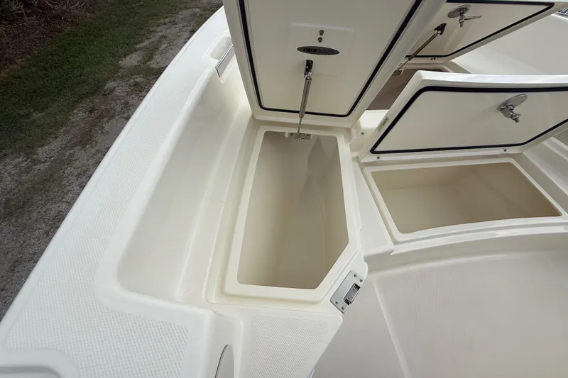 Slide: The Image of Open storage compartments on a 2025 Pathfinder 2400 TRS boat deck. - 46