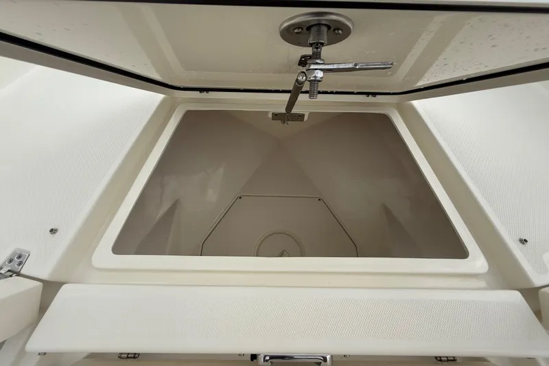 Slide: The Image of Open storage compartment on 2025 Pathfinder 2400 TRS boat, showcasing interior space. - 47