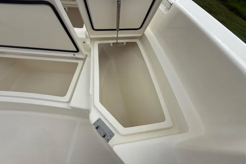 Slide: The Image of Open storage compartments on a 2025 Pathfinder 2400 TRS boat. - 48