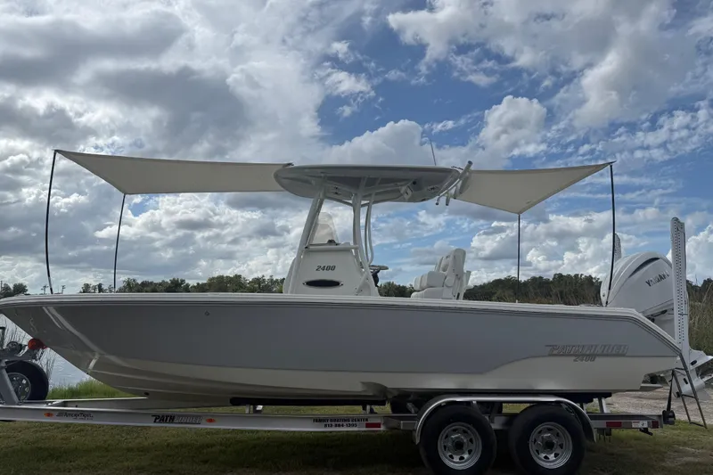 Slide: The Image of 2025 Pathfinder 2400 TRS boat on trailer under cloudy sky. - 51
