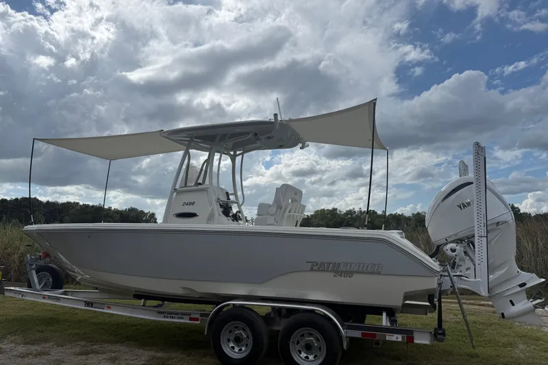 Slide: The Image of 2025 Pathfinder 2400 TRS boat on trailer under cloudy sky. - 52