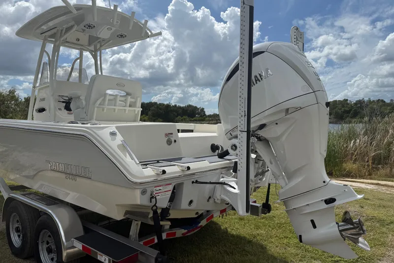 Slide: The Image of 2025 Pathfinder 2400 TRS boat with Yamaha engine on trailer, outdoors. - 6