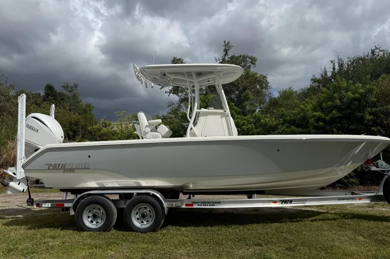 Slide: The Image of 2025 Pathfinder 2400 TRS boat on trailer, under cloudy sky, side view. - 9