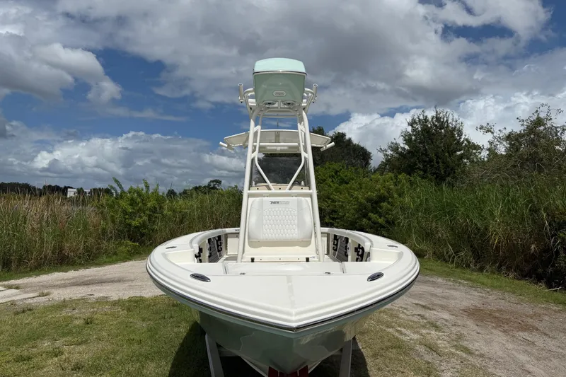 Slide: The Image of 2025 Pathfinder 2400 Open boat on grassy terrain under cloudy sky. - 11