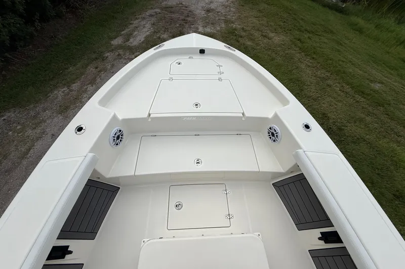 Slide: The Image of 2025 Pathfinder 2400 Open boat deck with storage compartments and speakers. - 19
