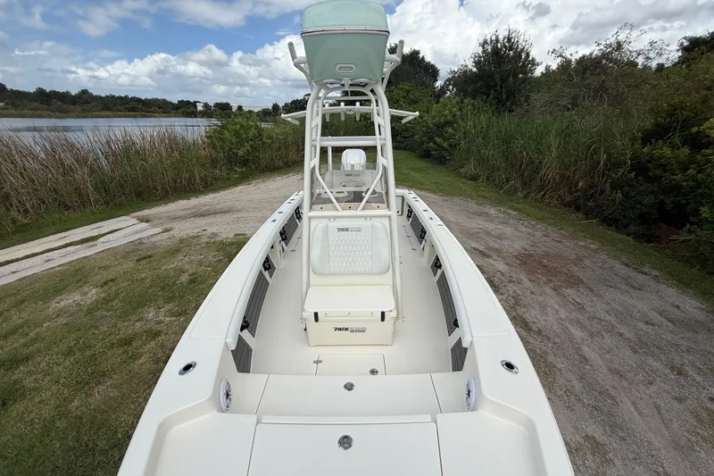 Slide: The Image of 2025 Pathfinder 2400 Open boat on grassy shore, under cloudy sky. - 21