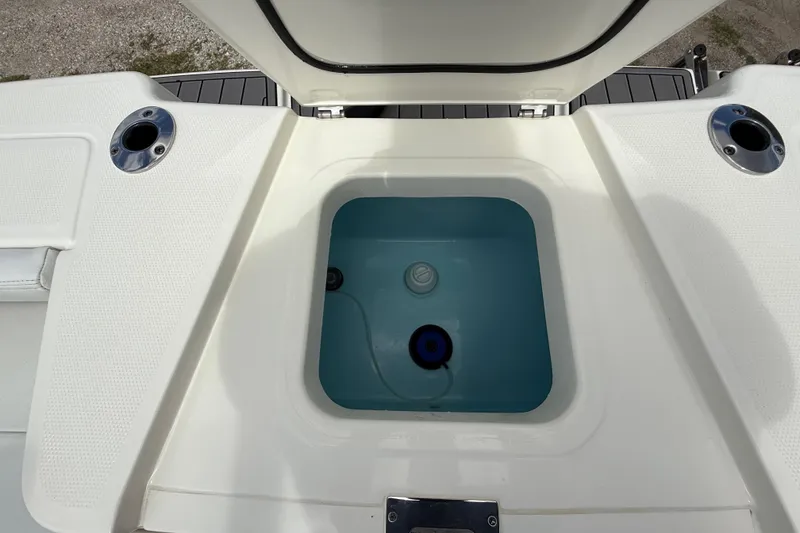 Slide: The Image of 2025 Pathfinder 2400 Open boat livewell with open lid and rod holders. - 28