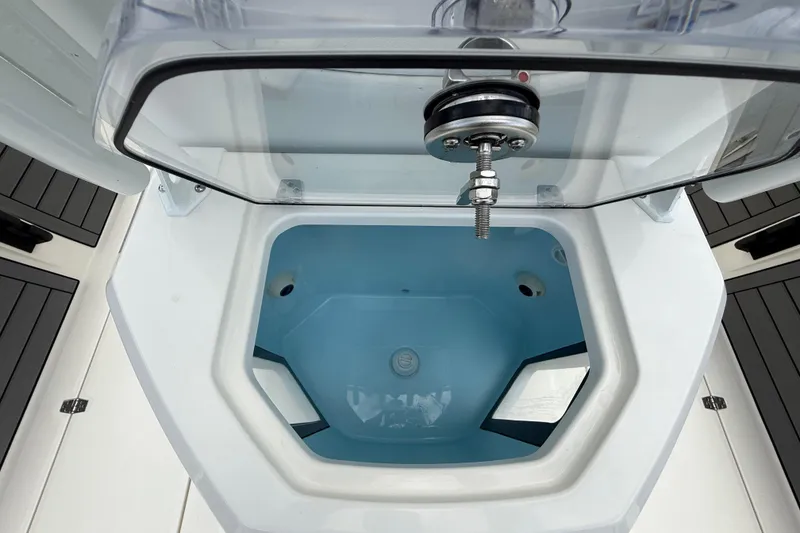 Slide: The Image of Livewell compartment on 2025 Pathfinder 2400 Open boat, featuring a clear lid and blue interior. - 31