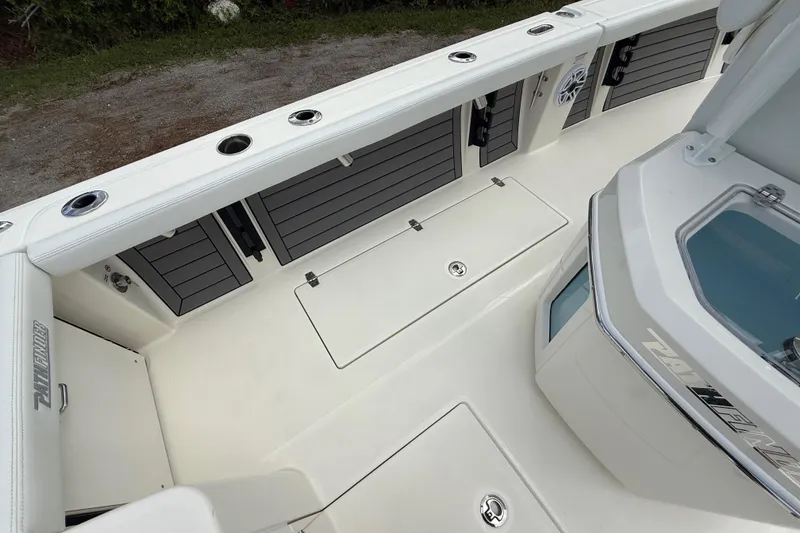 Slide: The Image of 2025 Pathfinder 2400 Open boat interior with storage compartments and rod holders. - 32