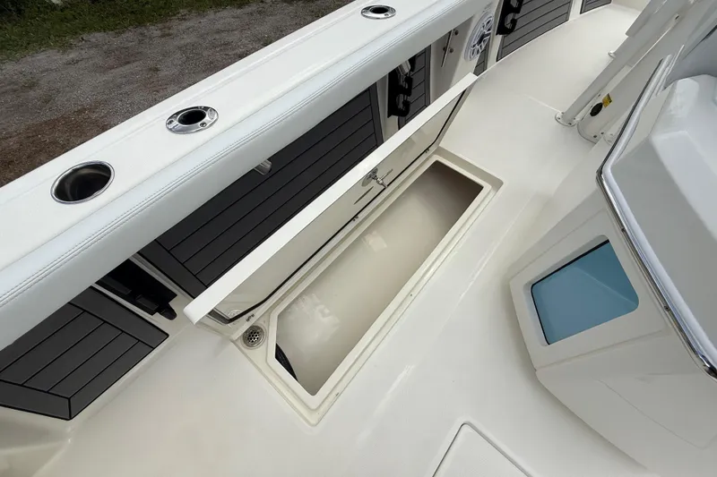 Slide: The Image of 2025 Pathfinder 2400 Open boat interior with storage compartment and cup holders. - 33
