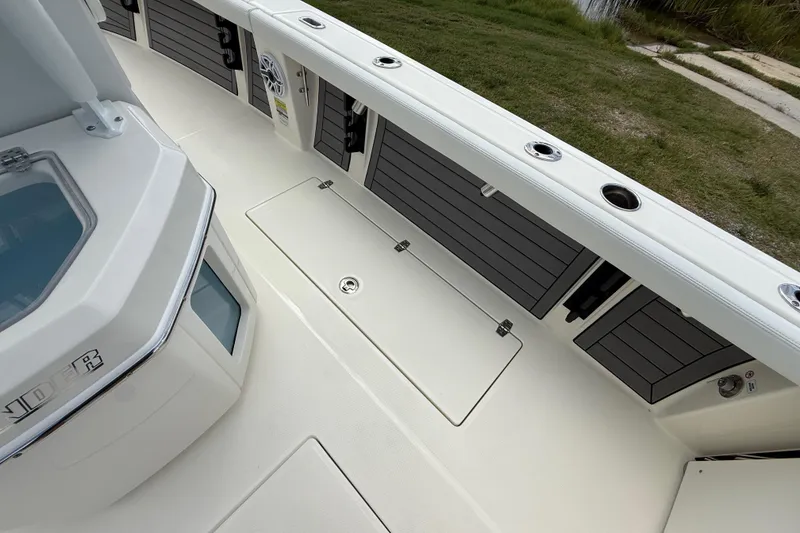 Slide: The Image of 2025 Pathfinder 2400 Open boat interior with storage compartments and sleek design. - 34