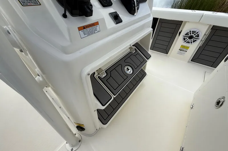 Slide: The Image of 2025 Pathfinder 2400 Open boat interior with storage compartment and speaker. - 38