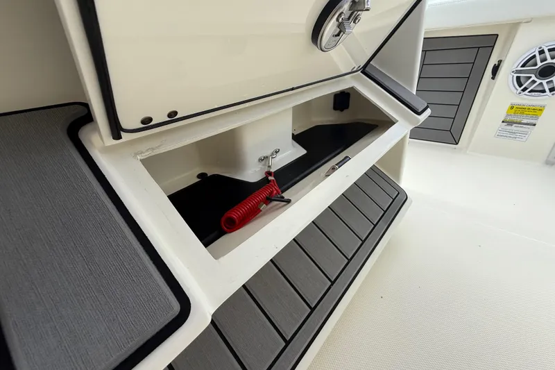 Slide: The Image of 2025 Pathfinder 2400 Open boat storage compartment with safety features and modern design. - 39