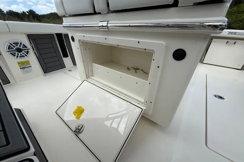 Slide: The Image of 2025 Pathfinder 2400 Open boat storage compartment with open hatch and visible speaker. - 41