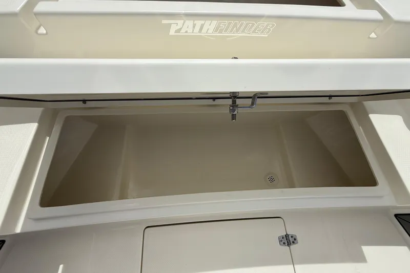 Slide: The Image of 2025 Pathfinder 2400 Open boat storage compartment with open lid and drainage. - 46
