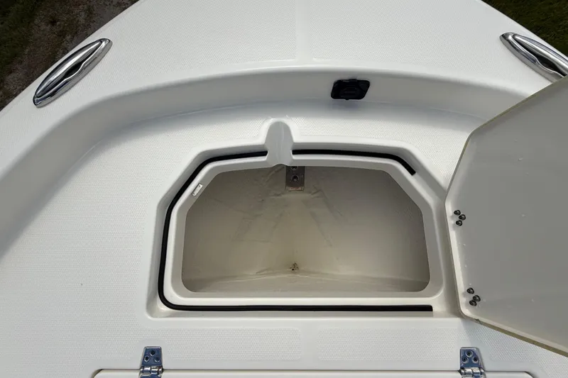 Slide: The Image of 2025 Pathfinder 2400 Open boat storage compartment with open hatch, showcasing interior space. - 48