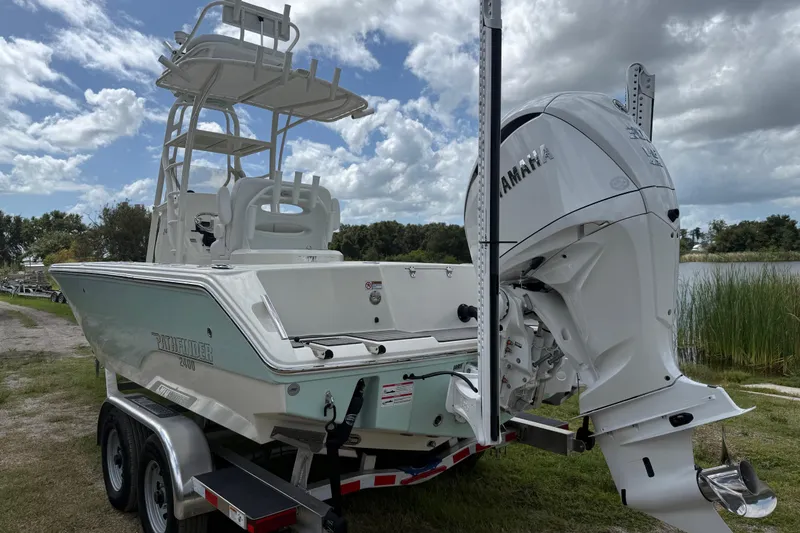 Slide: The Image of 2025 Pathfinder 2400 Open boat with Yamaha engine on trailer, parked near a lake. - 6
