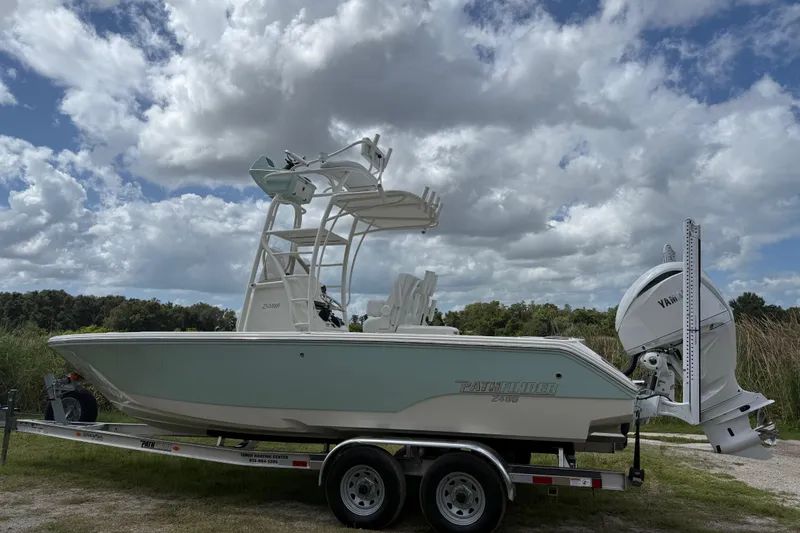 Slide: The Image of 2025 Pathfinder 2400 Open boat on trailer under cloudy sky. - 7