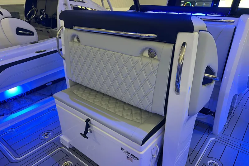 Slide: The Image of 2026 Nor-Tech 390 Sport Center Console interior with luxurious seating and ambient blue lighting. - 10