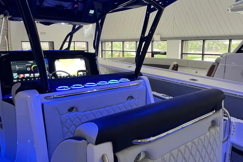 Slide: The Image of 2026 Nor-Tech 390 Sport Center Console interior with illuminated dashboard and seating. - 4