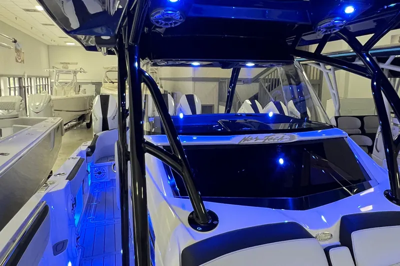 Slide: The Image of 2026 Nor-Tech 390 Sport Center Console with blue LED lighting in showroom. - 6