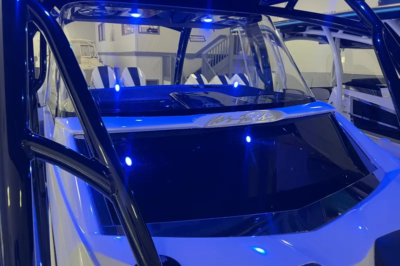 Slide: The Image of 2026 Nor-Tech 390 Sport Center Console with blue LED lighting in showroom. - 9