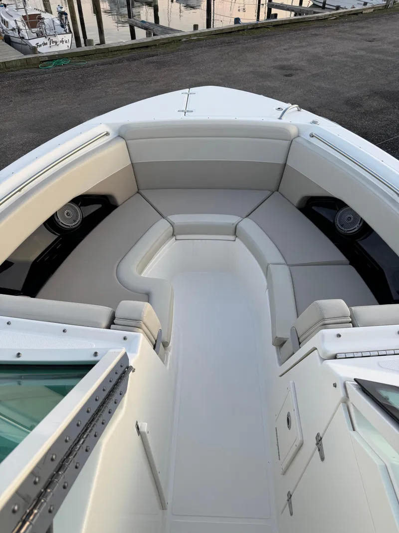 Slide: The Image of 2022 Boston Whaler 280 Vantage boat interior with cushioned seating and speakers. - 12