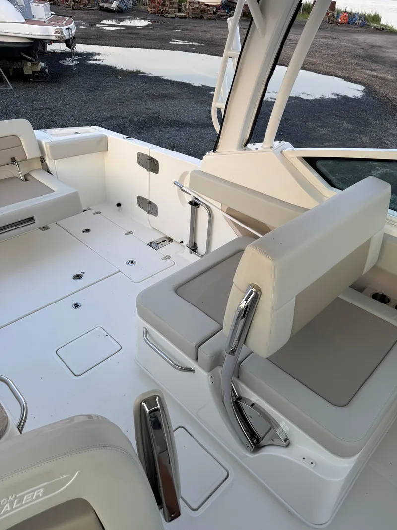 Slide: The Image of 2022 Boston Whaler 280 Vantage boat interior with seating and storage compartments. - 14