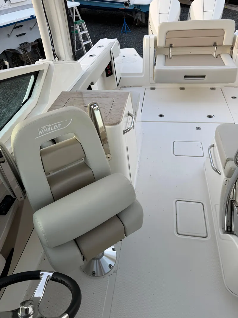 Slide: The Image of 2022 Boston Whaler 280 Vantage boat interior with seating and steering wheel. - 15