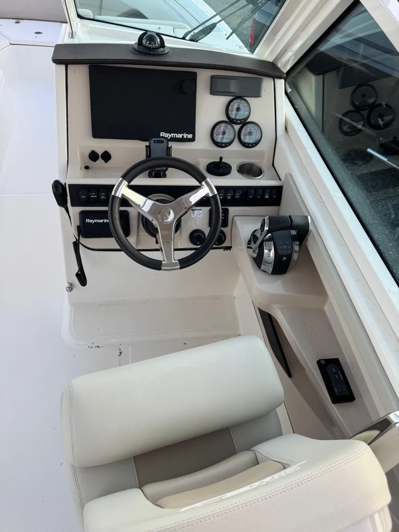 Slide: The Image of 2022 Boston Whaler 280 Vantage helm with Raymarine electronics and modern controls. - 2