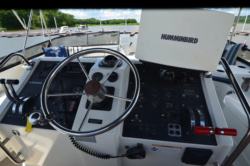 Slide: The Image of Helm of 1989 Carver Santego 3867 with steering wheel and Humminbird navigation system. - 17
