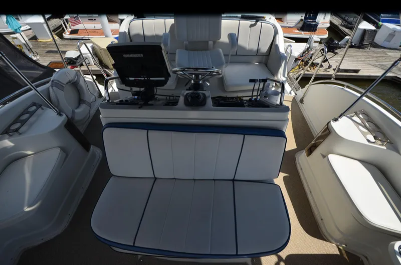Slide: The Image of 1989 Carver Santego 3867 yacht interior with seating and helm controls. - 18