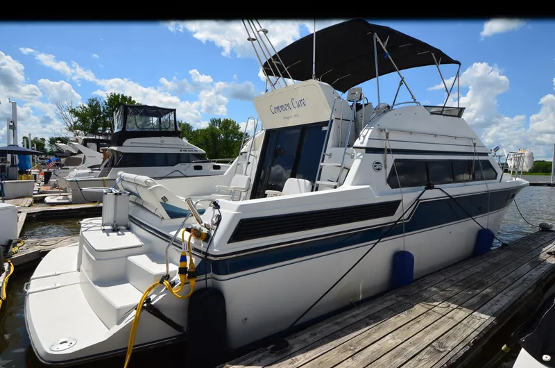 Slide: The Image of 1989 Carver Santego 3867 yacht docked at marina under blue sky. - 2