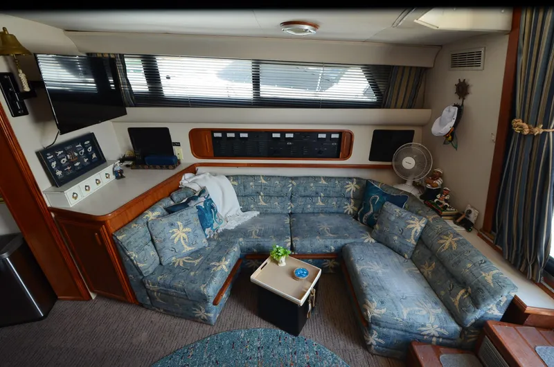 Slide: The Image of Interior of 1989 Carver Santego 3867 yacht with blue sectional sofa and nautical decor. - 26