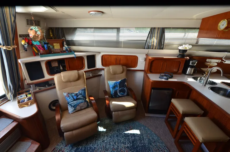 Slide: The Image of Interior of 1989 Carver Santego 3867 yacht with cozy seating and kitchenette. - 28